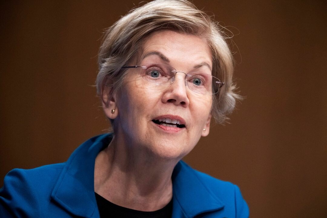 CRYPTONEWSBYTES.COM Senator-Elizabeth-Warren Senator Warren Grills US Gov’t Over 2-Year Delay on Crypto Tax Rules  