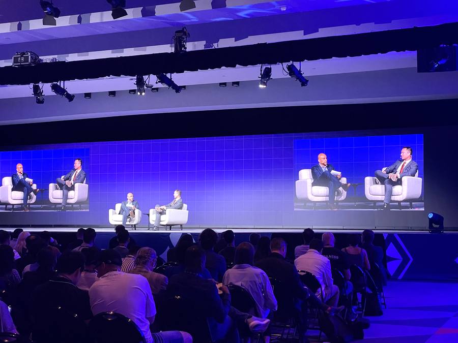 ETHConf 2026 Day 1 fireside chat on main stage, four speakers on white chairs