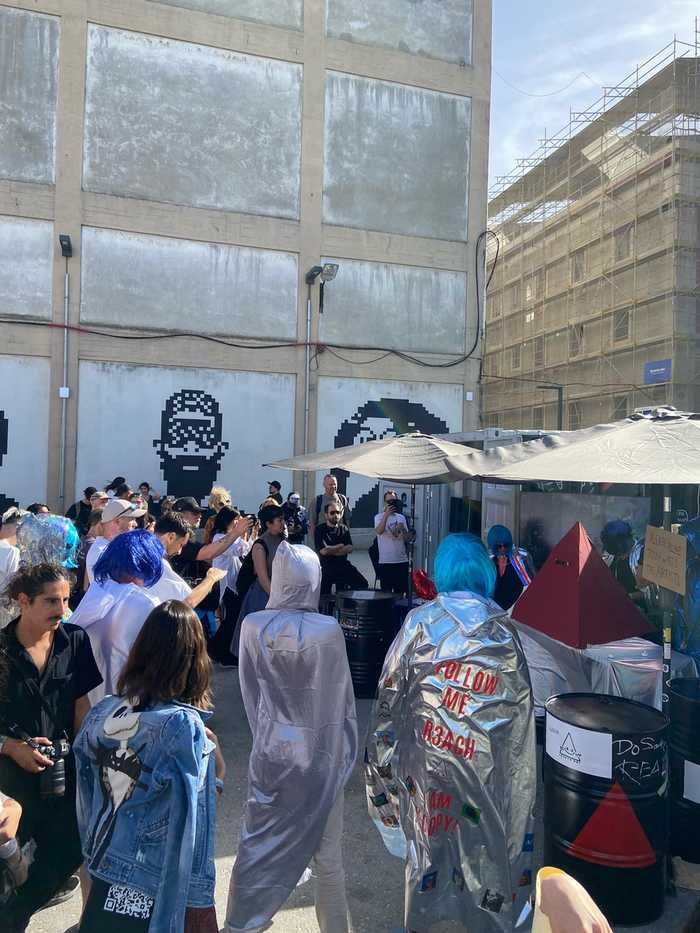 Crowd of costumed attendees at NFC Summit 2026 outdoor plaza, Unicorn Factory Lisboa