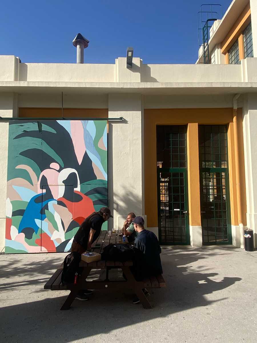 NFC Summit 2026 outdoor courtyard with colourful mural and attendees at picnic tables